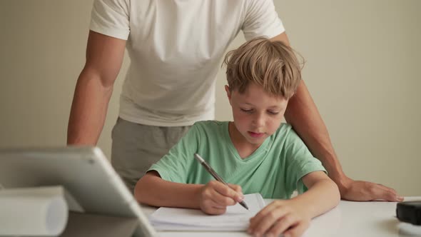 Father Helping Child Do His Homework at Home