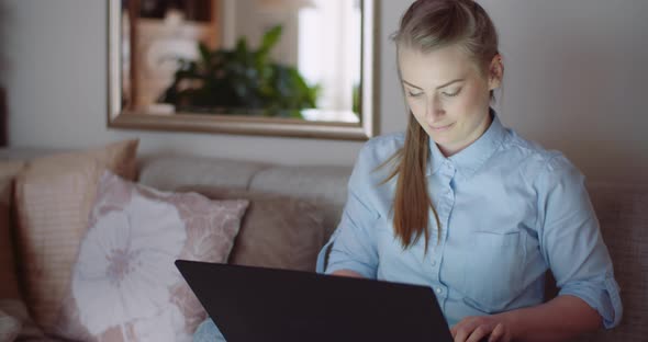 Smiling Woman Working on Laptop at Home Office. Businesswoman Typing on Computer Keyboard.