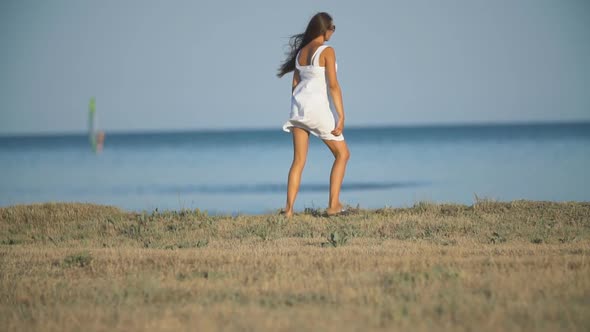 Girl in a White Dress Near the Sea