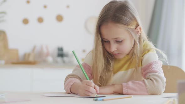 Caucasian Girl Drawing Using Coloured Pencils