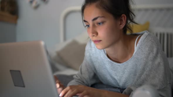 Young Woman Using Laptop at Home