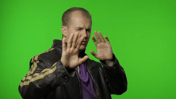 Confused Rocker Man Covering Eyes with Hand and Showing Stop Gesture, Expressing Disgust To Seen
