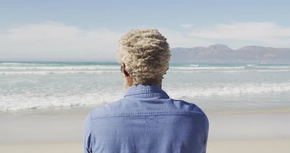 Senior african american man looking away on sunny beach