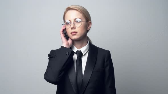 businesswoman in a classic business suit talking on mobile phone