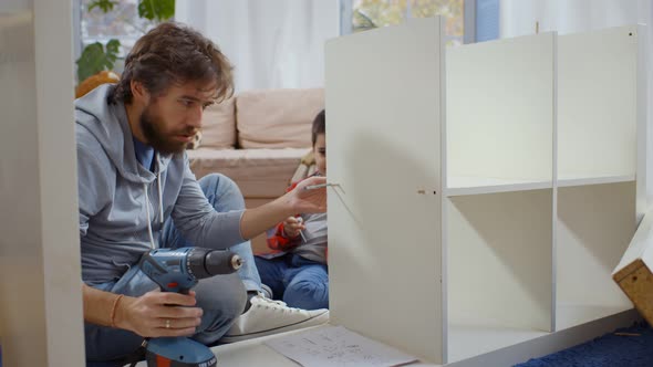 Father and Son Assembling Furniture at Home Together