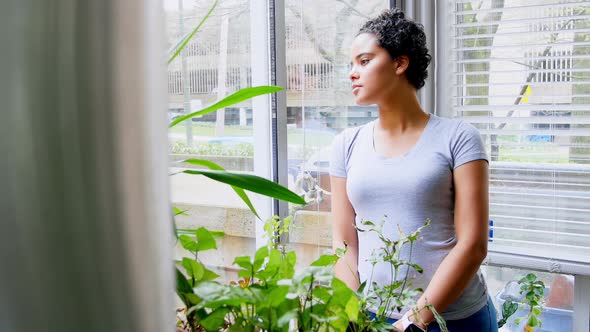 Thoughtful woman standing in the balcony 4k