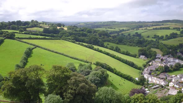 Pan right of the town of Launceston, cornwall, on a sunny summer afternoon, establishing shot