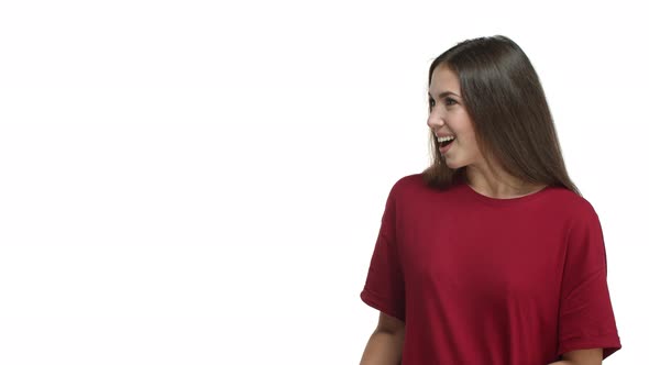 Video of Young Brunette Woman in Red Tshirt Turn Head at Something Interesting Pointing Fingers Left