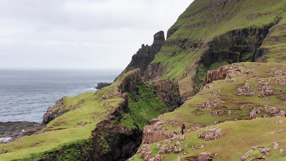 Aerial Back View of Huge Cliffs in Faroe Islands Green Rocky Mountainpowerful Ocean Wavesin a Cloudy