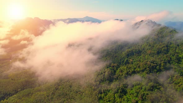 Drone flying above the clouds during sunrise