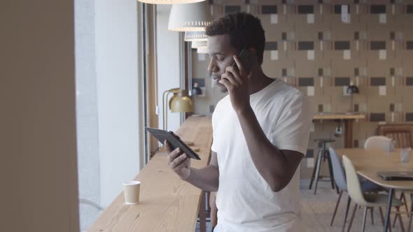 Serious African American Young Man Talking on Mobile Phone