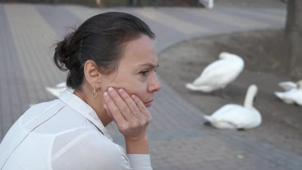 Woman in depression in city park. 