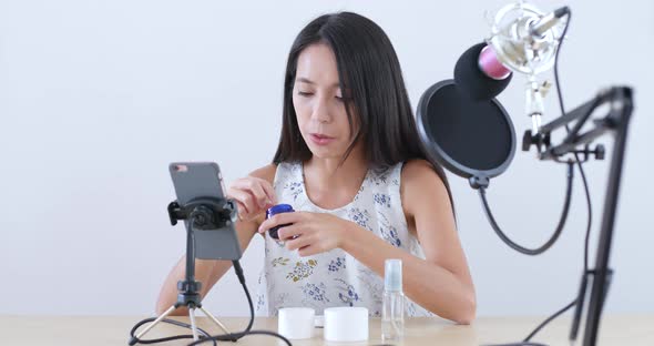 Young Woman having live stream on mobile phone 