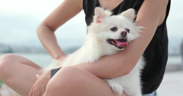 Woman hugging her dog at outdoor