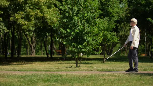 Blind Pensioner Safely Navigate Using White Cane, Walking Independent in Park