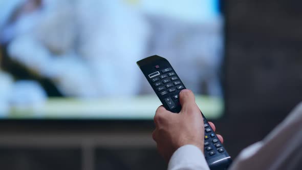 Back View of Businessman Using Tv Remote Control