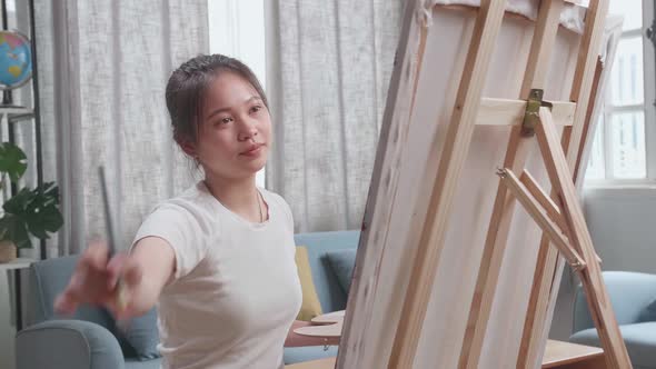 Talented Female Artist Energetically Using Paint Brush She Creates With Oil Painting