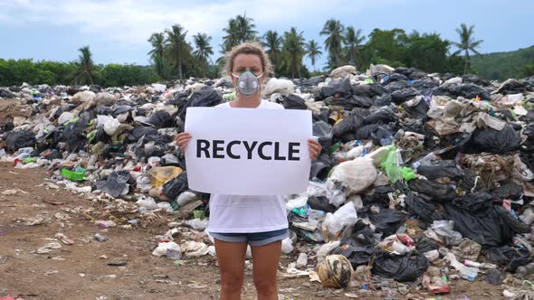 Female Activist on Waste Dump. Pollution and Environmental Problems.