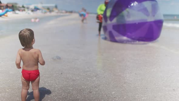 The Kid Looks at the Inflatable Big Balls