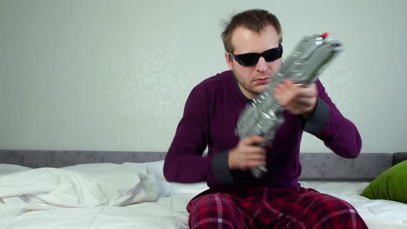 Strange Man with Black Glasses Pulls Jerks Foreend of Toy Blaster Gun, Shoots Directly at the Camera