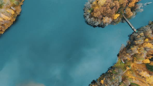 Sky Reflects in Blue Water Surrounded By Colorful Islands