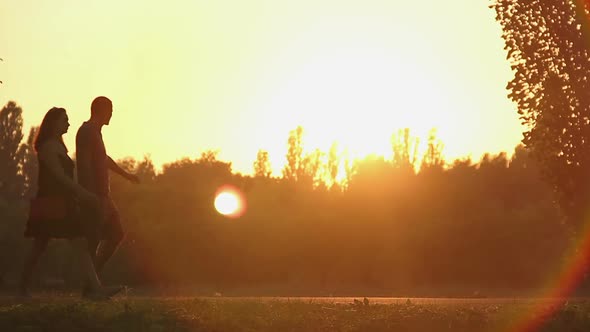 Happy Couple Spending Weekend Together, Walking by Hand in Golden Sunset Rays