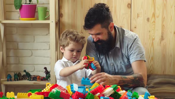 Preschool Teacher with Children Playing with Colorful Didactic Toys at Kindergarten.