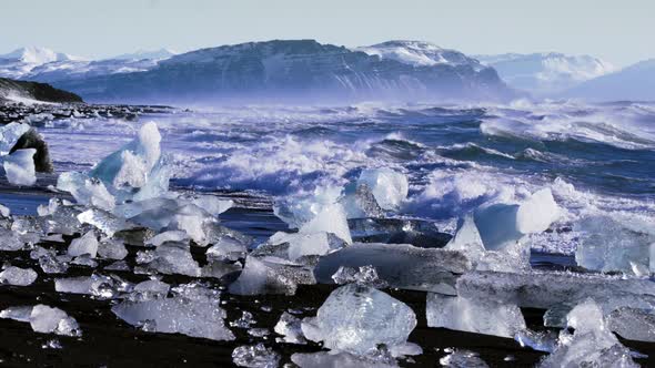 Ice From a Glacier Washing By Atlantic Ocean Waves on a Black Diamond Beach in Iceland
