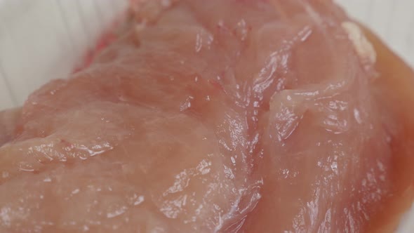 Slow pan over  frozen food close-up 4K 2160p 30fps UltraHD video - Chicken breasts packed in a box 3