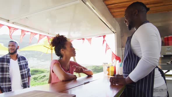 African american woman ordering food at the food truck