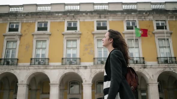 Pretty Young Female Tourist in Overcoat and Backpack