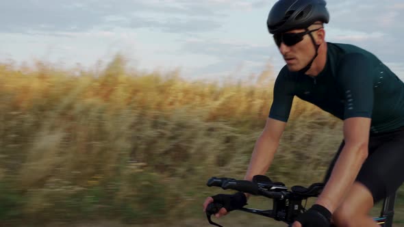 Portrait of cyclist man training on road bike