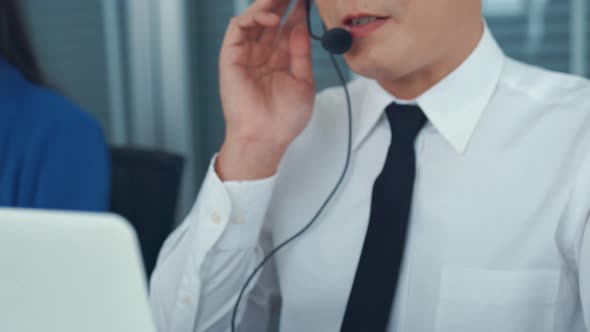 Businessman Wearing Headset Working Actively in Office