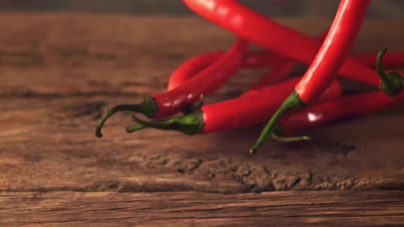 Super Slow Motion Red Chilli Falls on the Table