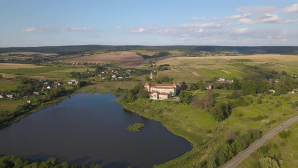 Aerial Drone Shot of Historic Castle on Hill Near Lake Medieval Architecture and Cultural Landmark