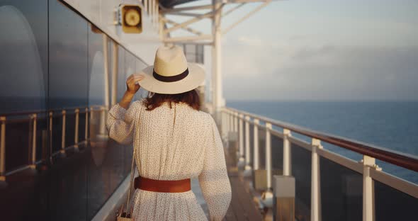 Young woman on a ship in the evening.