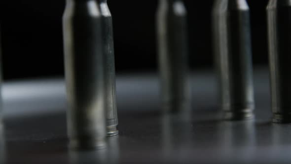 Cinematic rotating shot of bullets on a metallic surface - BULLETS 019