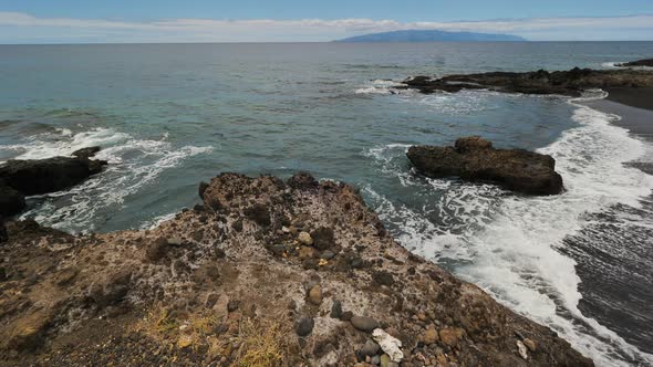 Static shot of the sea waves hitting the rocks