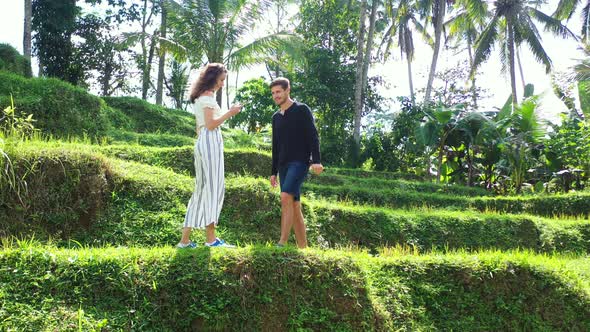 Vietnam, Asia, Romance in the jungle. Woman taking a photo of her boyfriend then checking it togethe