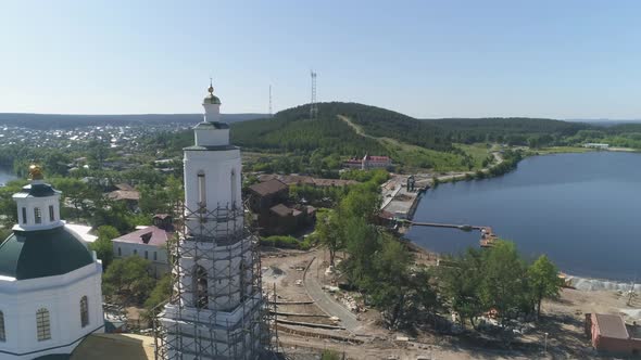 Aerial view of Construction of a embankment in the provincial town with church. 07