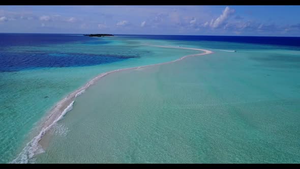 Aerial flying over scenery of idyllic coastline beach holiday by clear ocean with white sand backgro