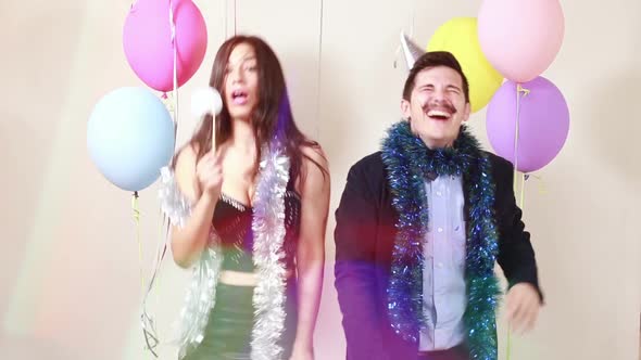 Slow motion of happy crazy couple enjoying in photo booth