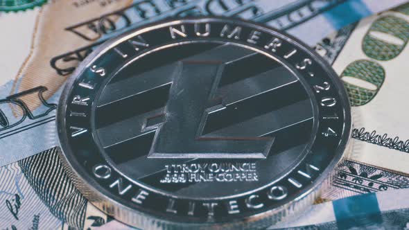 Silver Litecoin Coin LTC and Bills of Dollars Are Rotating