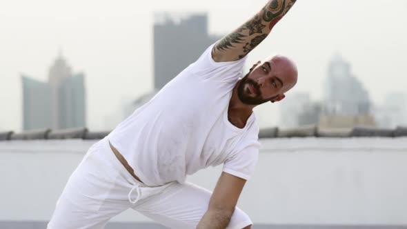 Caucasian Man Spreading His Arms Above His Cleanshaven Head While Gazing