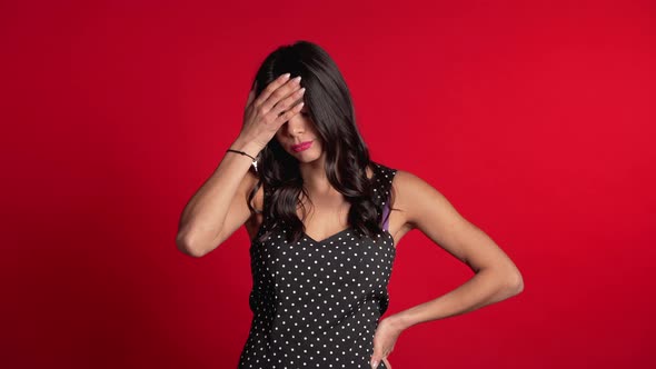 Frustrated Bored Hispanic Girl Over Red Wall Background. Woman Is Tired of Work