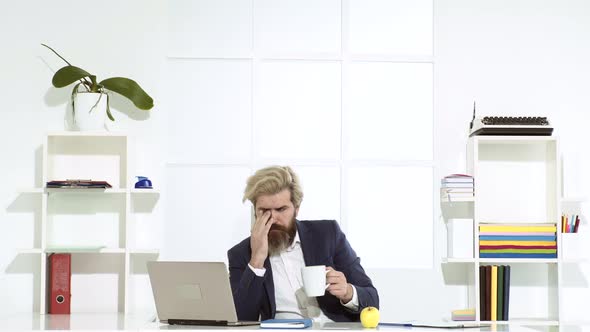 Office Worker Making Notes on the Documents. Elegant Businessman Analyzing Data in Office. Bearded