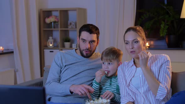 Happy Family with Popcorn Watching Tv at Home