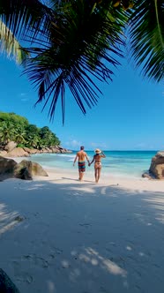 Anse Source d'Argent La Digue Seychelles Young Couple Men and Woman on a Tropical Beach During a