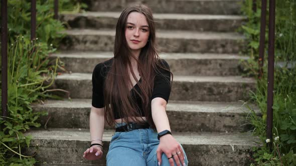 Nice Girl Posing While Sitting on the Stairs