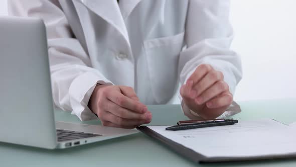 Doctor and Patient Discussing Health Treatment While Sitting at the Desk.